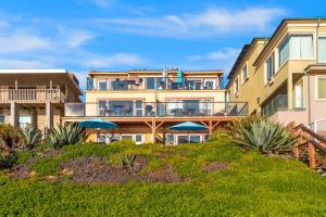 a building with a balcony with umbrellas at 3009 Ocean Street in Carlsbad