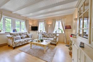 a living room with two couches and a coffee table at Landhaus Vilmnitz - Wohnung 10 in Vilmnitz