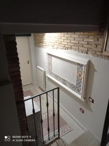 a hallway with a staircase with a window and a brick wall at B&B Giallo Siena in Colli al Volturno