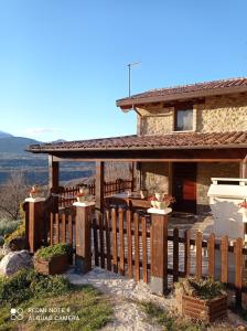 a house with a wooden fence in front of it at B&B Giallo Siena in Colli al Volturno