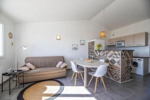 a living room with a couch and a table at Résidence Santa Monica in Bonifacio