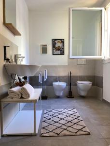 a bathroom with two toilets and a sink and a sink at Casimiro Home in Cesena