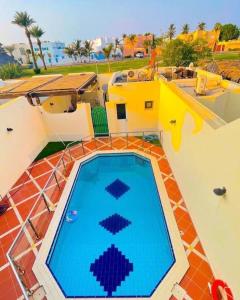 a large swimming pool on top of a house at درة العروس فيلا البيلسان الشاطي الازرق in Durat Alarous