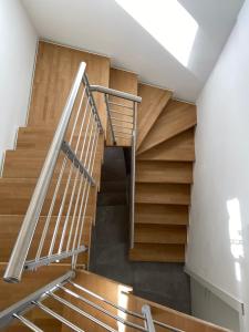 a spiral staircase in a building with wooden steps at Casimiro Home in Cesena