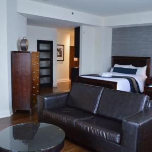 a living room with a couch and a bed at Sterling Inn & Spa in Niagara Falls