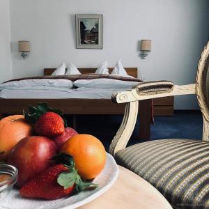 a plate of fruit on a table next to a bed at Thermalhotel Regina Terme in Leukerbad