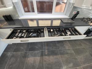 a kitchen with a stove top oven in a kitchen at High Spec Large 6 Bedroom House! in Kingston upon Thames