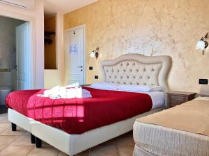 una camera da letto con un grande letto con una coperta rossa di B&B Desenzano Paradise a Desenzano del Garda