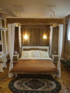 a bedroom with a bed with a canopy at Classic Apartment on Kievyan in Yerevan