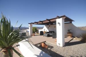 a backyard patio with a pergola and a couch at Villa Alta Vista in Albox +35 photos