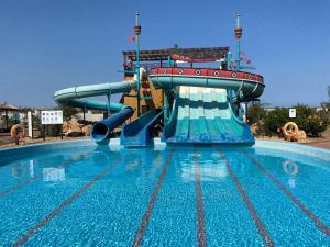 a large swimming pool with a water slide at Quality Melia Dunas Beach Resort Apt Spa Gym 7 Pools in Santa Maria