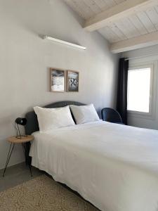 a bedroom with a large white bed and a window at Casimiro Home in Cesena