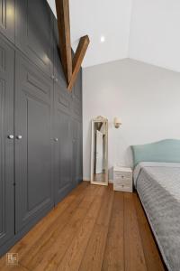 a bedroom with a bed and a mirror at Cozy Old Town apartment in Kaunas