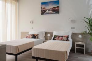 Postel nebo postele na pokoji v ubytování Nido Suite & Apartments