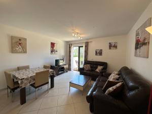 a living room with a couch and a table at Quality Melia Dunas Beach Resort Apt Spa Gym 7 Pools in Santa Maria