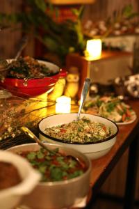 a table topped with bowls of food on a table at Alaya Poleg in Netanya