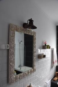 a mirror on a wall in a bathroom at Casa Da Torre in Ribeira Grande