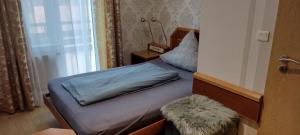 a small bedroom with a bed and a window at Hotel Zur Rose in Bad Karlshafen