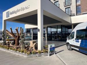 a white van parked in front of a building at Holiday Inn Express - Ankara - Airport by IHG in Ankara