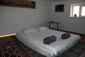 a bed with two pillows on it in a room at East in Baku