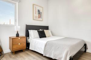 a bedroom with a bed and a nightstand and a window at Silverlake 1br w wd roof nr 5 10 freeways LAX-978 in Los Angeles