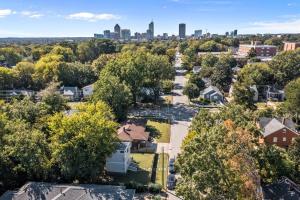 an aerial view of a residential neighborhood with a city skyline at Downtown Guest House in Raleigh