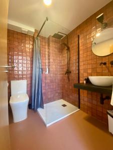 a bathroom with a shower and a toilet and a sink at Smart Apartments Tarifa, Parking facil y aire acondicionado in Tarifa +50 photos