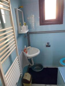 a small bathroom with a sink and a toilet at Mićin dom in Pirot