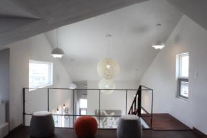 a room with a glass table and two stools at Warak Guesthouse in Jeju