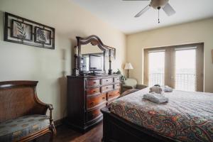 a bedroom with a bed and a dresser and a mirror at MVC - Unit 2507 in Pigeon Forge +46 photos