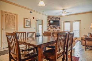 a dining room and living room with a wooden table and chairs at MVC - Unit 3606 in Pigeon Forge