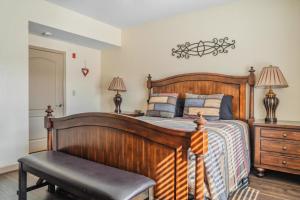 a bedroom with a wooden bed and a chair at MVC - Unit 3207 - Happy Place in Pigeon Forge