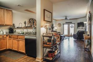 a kitchen with a black refrigerator and wooden cabinets at MVC - Unit 5707 - Hawks Nest in Pigeon Forge