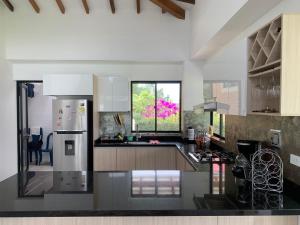 a kitchen with a refrigerator and a counter top at Casa Campestre Altamira in Los Curos