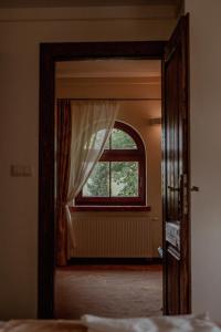 an open door to a bedroom with a window at Olandia in Kwilcz