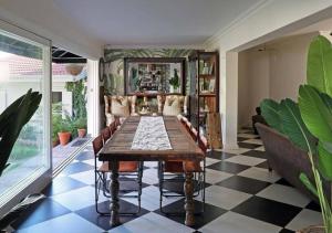 a dining room with a table and a checkered floor at The Bungalow Umhlanga in Durban