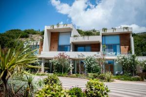 a house on the side of a hill with plants at Soleil Village & Villas in Jal