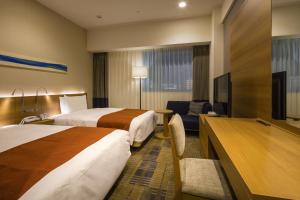 Postel nebo postele na pokoji v ubytování Hotel Sunroute Chiba