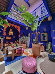 a room filled with lots of plants and tables at Casa Amina in Chefchaouene