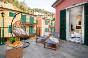 a balcony with a chair and a swing at Olives Bay Terrace in Portofino in Portofino