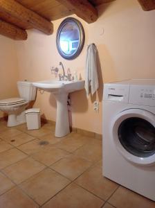 a bathroom with a sink and a washing machine at Palazzo con Vista in Corfu