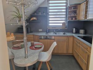 a kitchen with a table and chairs and a sink at Ostorfer See in Schwerin +7 photos