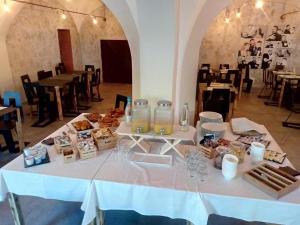 a white table with food and drinks on it at Hotel La Smorfia in Castiglioncello