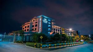 a large building with a clock on it at night at Crowne Plaza Nairobi Airport by IHG in Nairobi