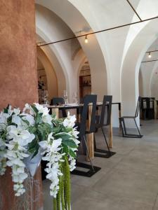 a dining room with a table and chairs and white flowers at Hotel La Smorfia in Castiglioncello
