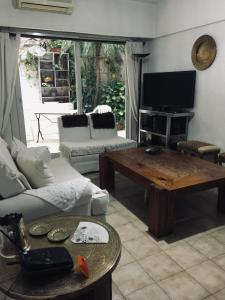 a living room with a couch and a table at departamento en Retiro 1dormitorio in Buenos Aires