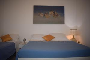 A bed or beds in a room at La Cecia - Casa vacanze nella campagna salentina