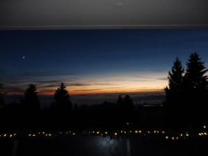 a view of the sunset from a hill with trees at Komfortable Wohnungen und Studio in Sankt Englmar in Sankt Englmar