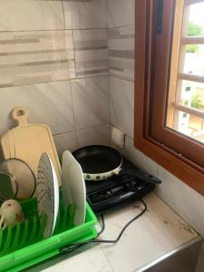 a kitchen counter with a stove and some dishes at Résidence Hadja 02 in Dakar