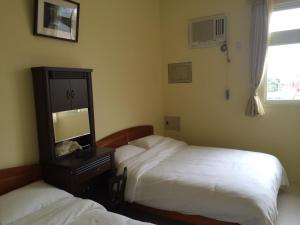 Postel nebo postele na pokoji v ubytování Dragon House B&B
